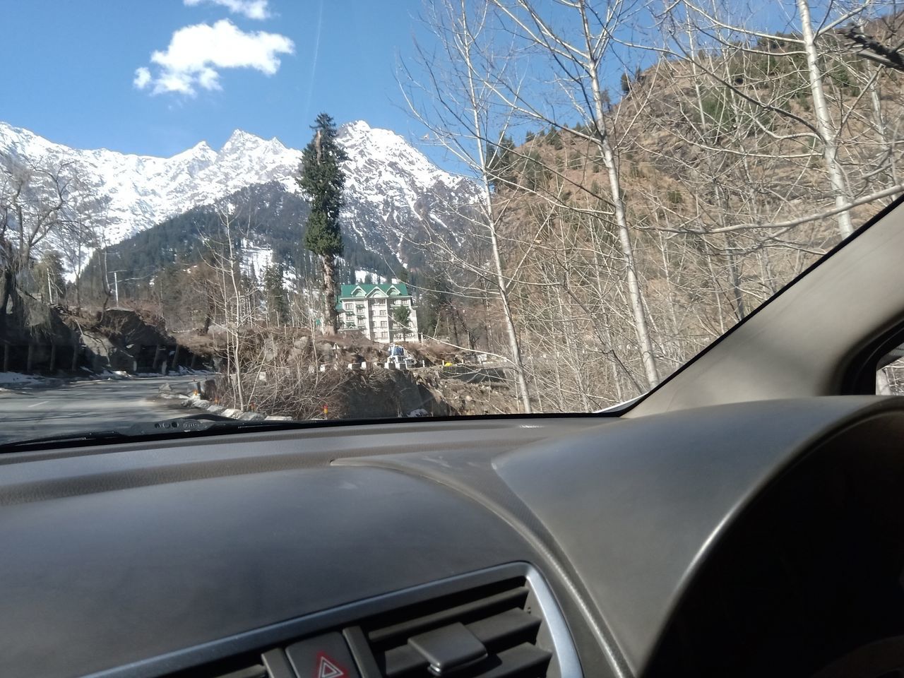 VIEW OF CAR WINDSHIELD ON SNOW COVERED STREET