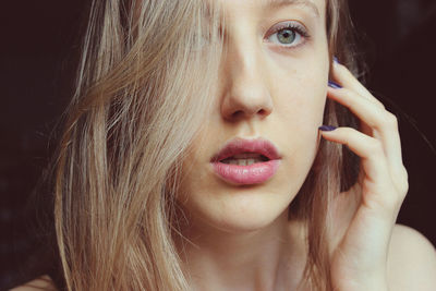 Close-up of thoughtful young woman at home