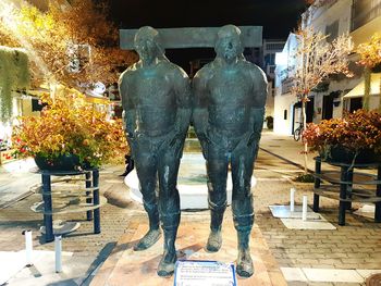 View of statues in city at night