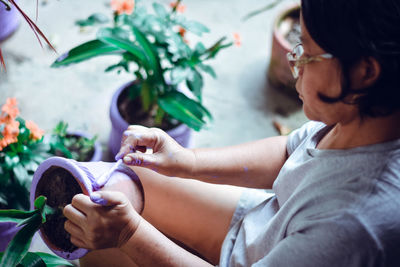 Midsection of women holding plant