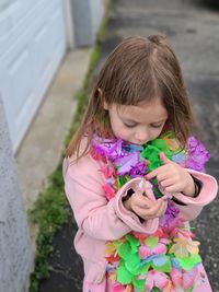 Cute girl wearing floral garlands standing outdoors
