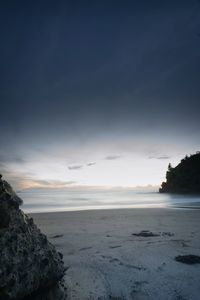 Scenic view of beach against sky during sunset