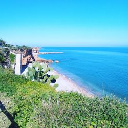 Scenic view of sea against clear blue sky