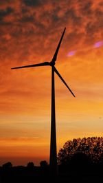 Low angle view of windmill against sky during sunset