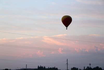 Low angle view of hot air balloons against sky during sunset