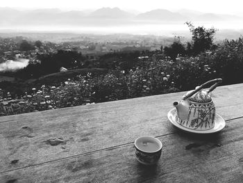 Close-up of coffee on table against mountains