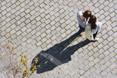 Woman standing on footpath