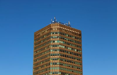 Low angle view of building against clear blue sky