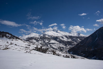 Scenic view of snowcapped mountains against sky