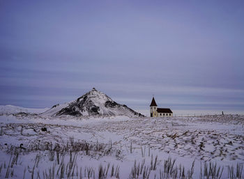 Scenic view of snowcapped mountain against sky during winter