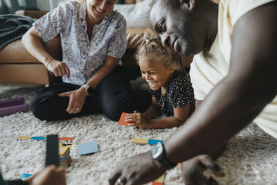 Happy family having fun playing games together at home