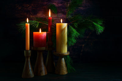 Close-up of illuminated candles on table