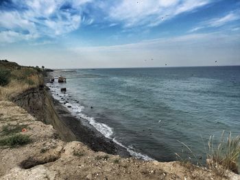 Scenic view of sea against cloudy sky