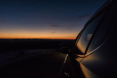 Cars on road at sunset