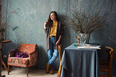 Portrait of young woman sitting on sofa