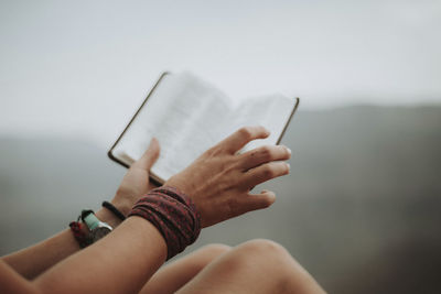 Cropped image of woman holding book at grand canyon national park