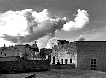 Buildings against cloudy sky