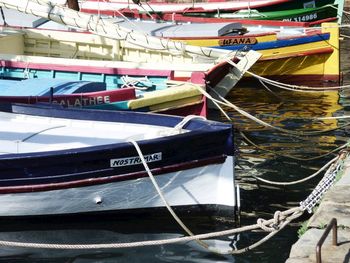 Close-up of sailboats moored at harbor