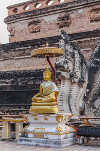 Buddha statue against temple