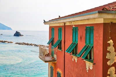 House by sea against clear sky