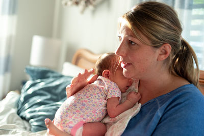 Mother and daughter on bed