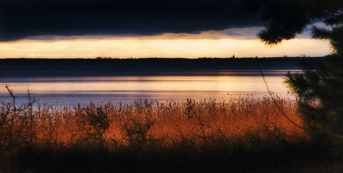 Scenic view of lake against sky during sunset