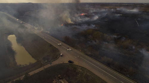 Massive fire, dry grass lanes in fire, firefighters at work, disaster, ecological catastrophe