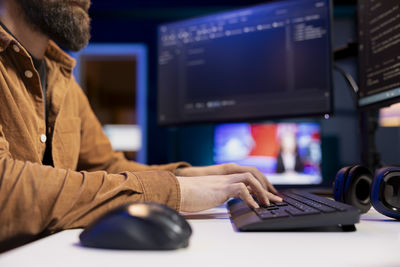 Midsection of businesswoman using laptop