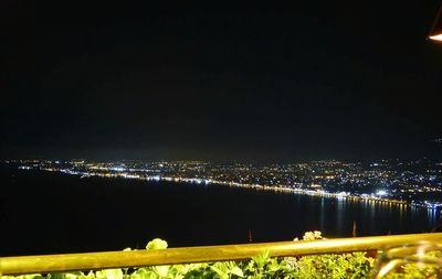 High angle view of city lit up at night