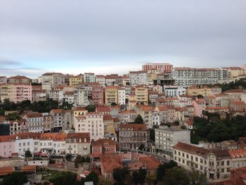 View of cityscape against cloudy sky