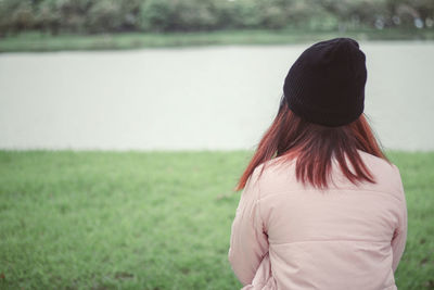 Rear view of woman standing on field