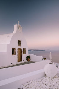 Building by sea against sky