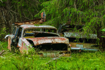 Abandoned car on field