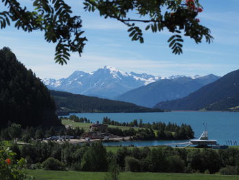 Lago di resia - italy. scenic view of lake by mountains against sky