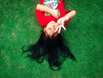 Portrait of girl lying on grassy field