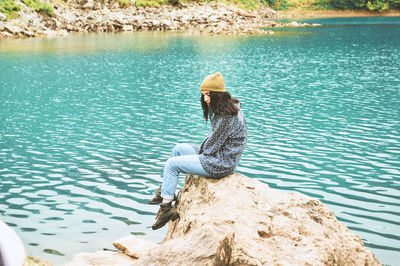 Woman sitting on the lake