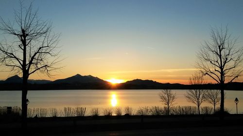 Scenic view of lake against sky during sunset