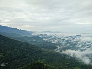 Idyllic shot of mountains in foggy weather against cloudy sky