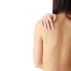 Rear view of shirtless woman against white background