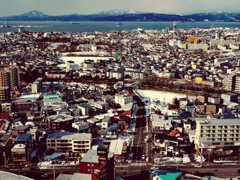 High angle shot of townscape against sea