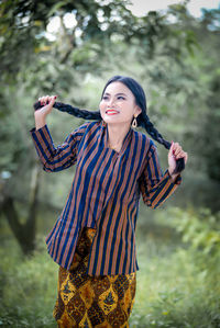 Portrait of young woman standing outdoors