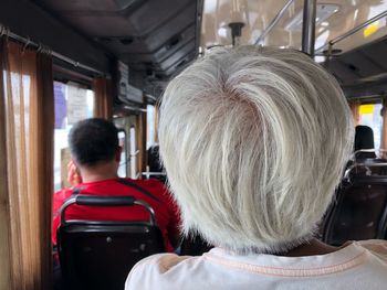 Rear view of people sitting in bus