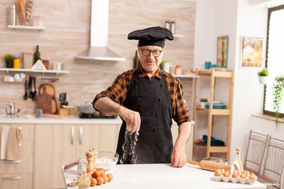 Midsection of woman preparing food in kitchen