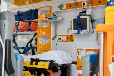 Interior of contemporary ambulance car equipped with various professional instruments and medical stretcher