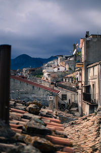 Buildings in town against sky