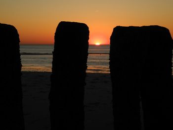 Scenic view of sea against orange sky