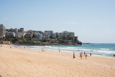 People on beach against sky