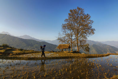 Man standing on mountain against sky