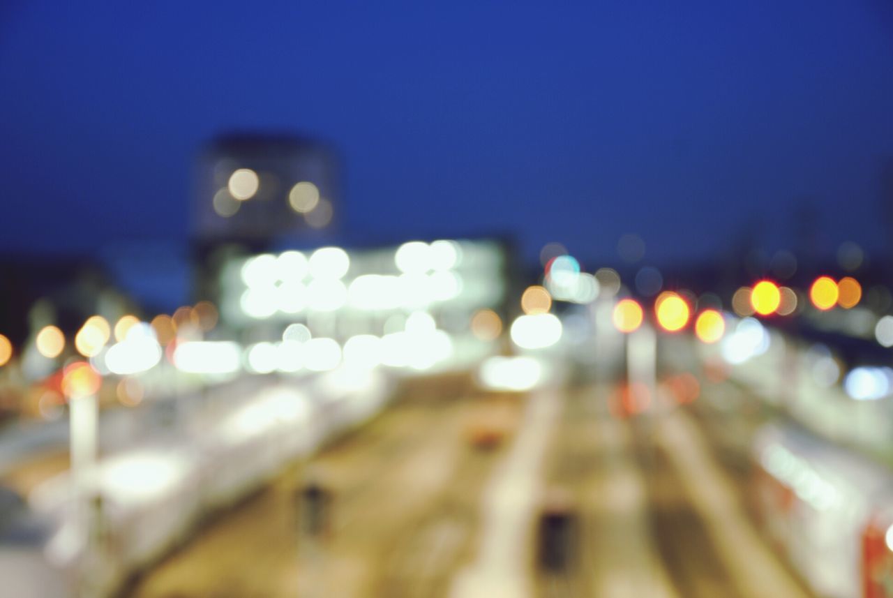 illuminated, night, defocused, lighting equipment, transportation, city, street, light - natural phenomenon, road, street light, car, selective focus, no people, building exterior, lens flare, land vehicle, city street, multi colored, outdoors, architecture