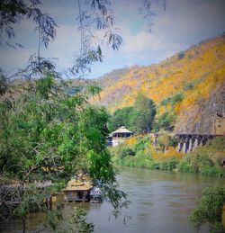 Scenic view of river by trees against sky during autumn